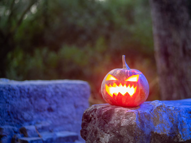A closeup shot of a scary pumpkin lighten from the inside for a Halloween party - Zdjęcie, obraz