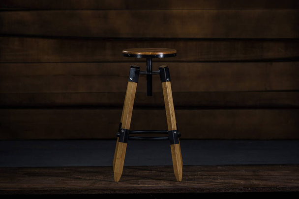 A tall wooden stool in a studio - 写真・画像