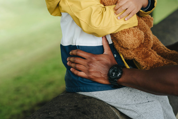 An African-American child holding a teddy bear - Fotoğraf, Görsel