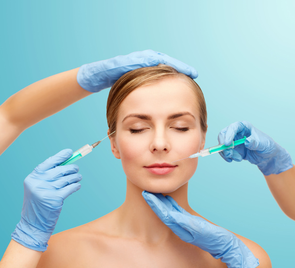 Woman face and beautician hands with syringe - Foto, Imagen