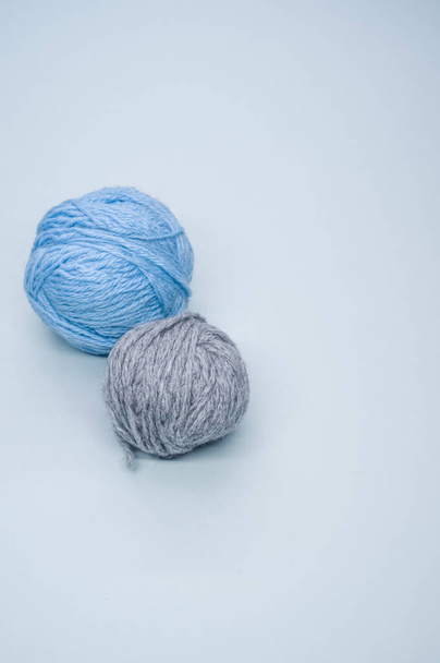 Two wool and cotton yarns on a gray background - Fotoğraf, Görsel