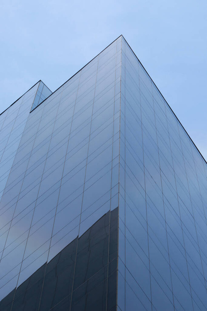 A vertical low angle shot of a tall glass building at daytime - Valokuva, kuva