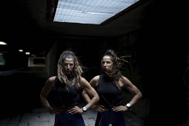 A closeup shot two fierce Spanish women on a dark background - Фото, зображення