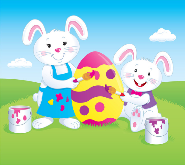 twee konijnen schilderen een grote easter egg - Foto, afbeelding