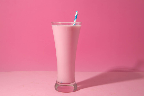A glass of strawberry smoothie isolated on pink background - Zdjęcie, obraz