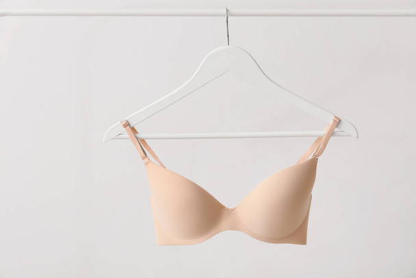 Hanger with stylish bra on light background - Photo, Image