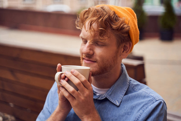 Close up portrait of handsome man drinking coffee - Photo, image