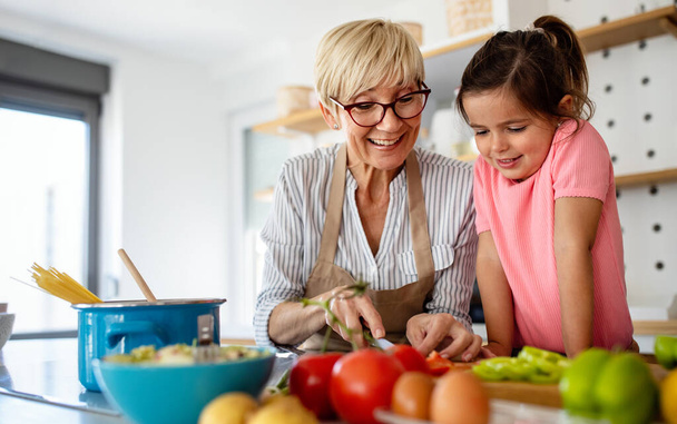 Family fun love generation concept. Grandmother and granddaughter are cooking on kitchen. - Foto, imagen