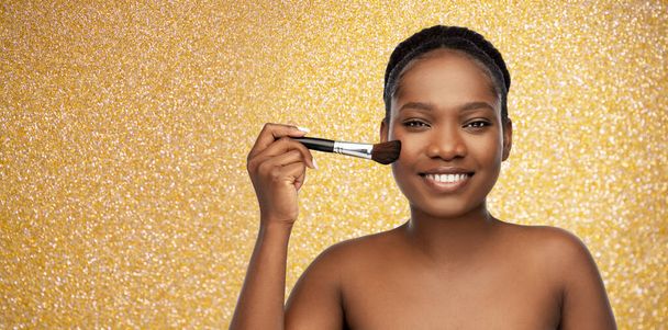 woman with make up brush applying blush to face - Фото, зображення