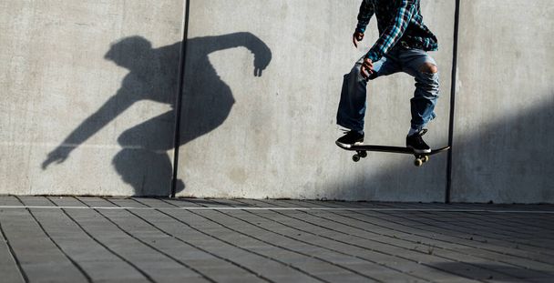 Skateboarder riding fast towards the ramps to be lifted into the air and perform a trick - Фото, зображення