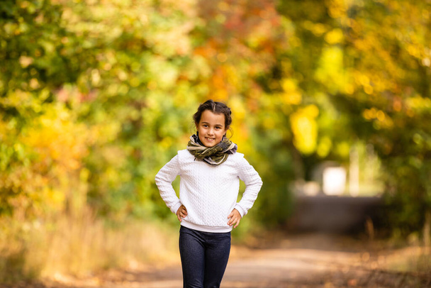 Φθινοπωρινό πορτρέτο του χαριτωμένου μικρού καυκάσιου κοριτσιού - Φωτογραφία, εικόνα