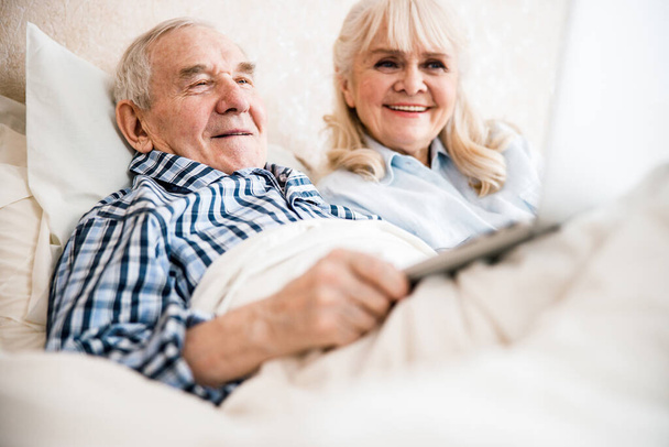 Senior couple having good time at home - Fotó, kép
