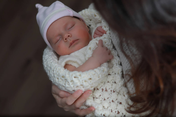 Baby newborn sleeping wrapped up in a warm blanke - Photo, Image
