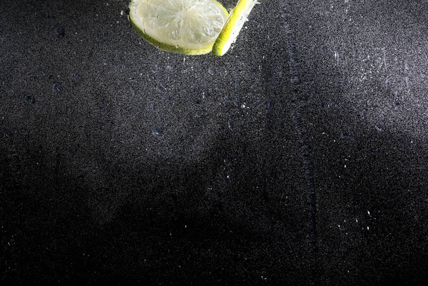 Gotas de agua sobre limón dulce maduro. Fondo de cal fresca con espacio de copia para su texto. Concepto vegano y vegetariano. - Foto, Imagen