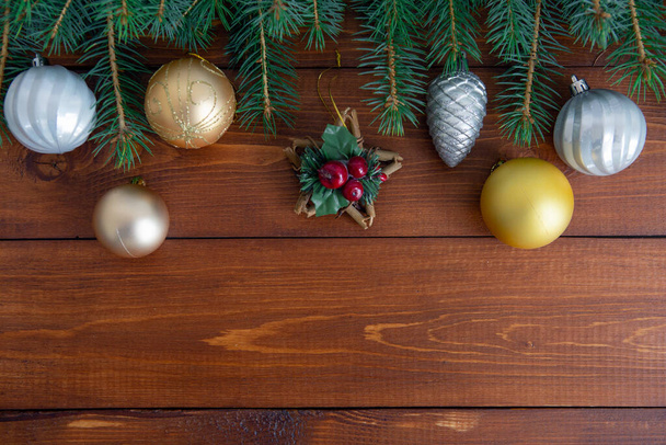 Christmas background with a Christmas tree and decoration on a dark wooden Board. The view from the top - Photo, Image