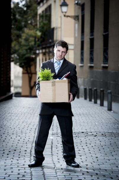  frustrated business man on street fired carrying cardboard box  - Foto, immagini