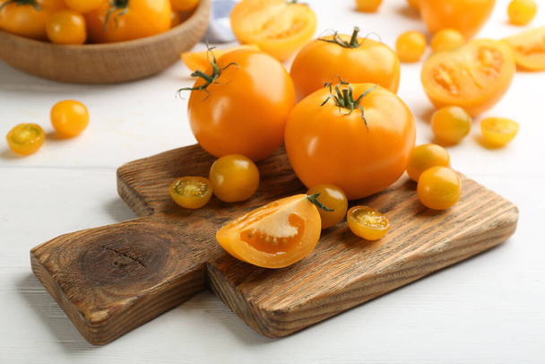 Ripe yellow tomatoes on white wooden table - Fotoğraf, Görsel