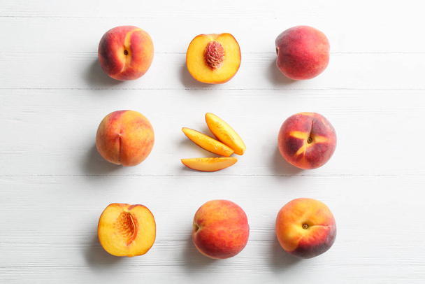 Fresh sweet peaches on white wooden table, flat lay - Photo, Image