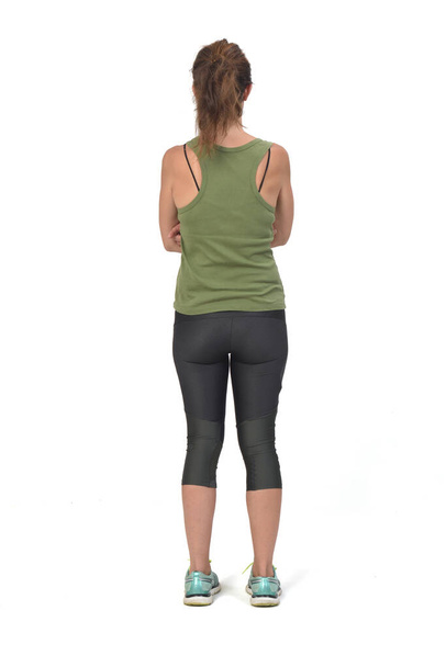 rear view of a woman with sportswear on white background,  - Foto, Imagen