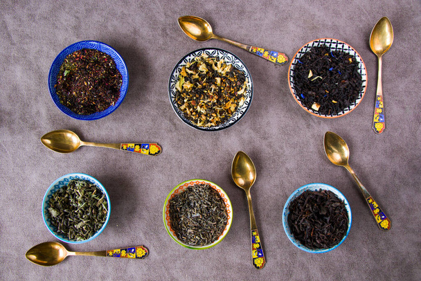 Herbal and natural dry tea set, variation and collection of tea and vintage spoons - Photo, image
