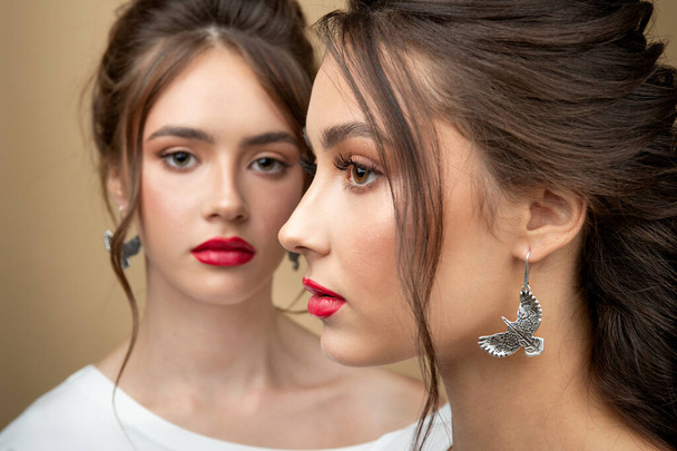 Portrait of  two sexy woman perfect face cosmetic skin care beauty salon hairdo hair style model blush mascara lipstick collection accessory jewelry earrings cream young pure lotion friends - Photo, image