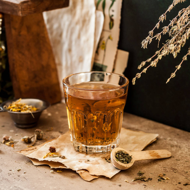 Herbal Tea in a Glass and Variety of Dried Herb Mixes, square - Zdjęcie, obraz