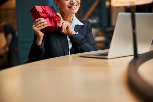 Close up of pleased woman that getting present - Фото, изображение