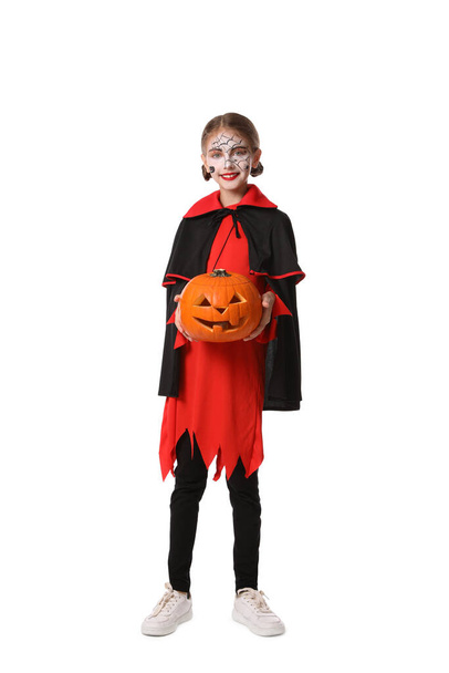 Cute little girl with pumpkin wearing Halloween costume on white background - Foto, afbeelding
