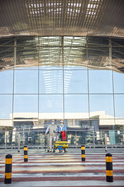 Seniorzy stojący w pobliżu terminalu lotniska - Zdjęcie, obraz