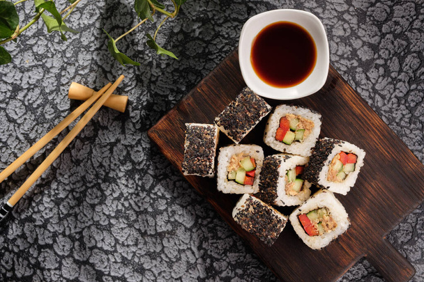 Roll with vegetables and fish paste with a sesame cap. Sushi menu bar. Japanese food Sushi served top view. Delicious food. - Zdjęcie, obraz