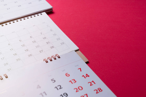 close up of calendar on the red table background, planning for business meeting or travel planning concept - Foto, immagini
