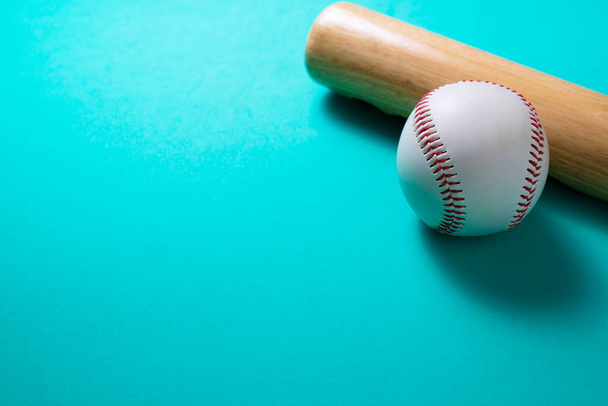 baseball and baseball bat on green table background, close up - Photo, image