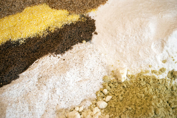 Background from different types of flour: rice, chickpea, pumpkin, cassava, corn and buckwheat flour. - Photo, Image