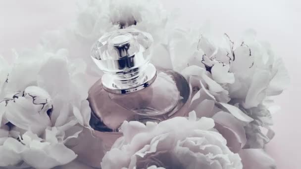 White perfume bottle with peony flowers, chic fragrance scent as luxury cosmetic, fashion and beauty product background - Footage, Video