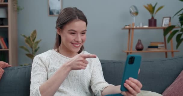 Cheerful deaf woman having video call and showing with sign language Hello, how are you Female pretty person smiling and using smartphone for communication. Concept of hear loss. - Filmati, video