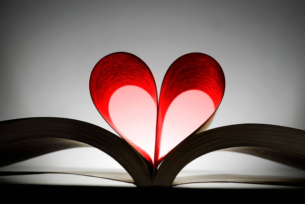 Book with heart shaped pages showing a love of reading books and learning - Fotó, kép