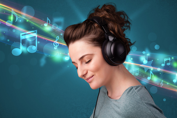 Young woman listening to music with headphones - 写真・画像