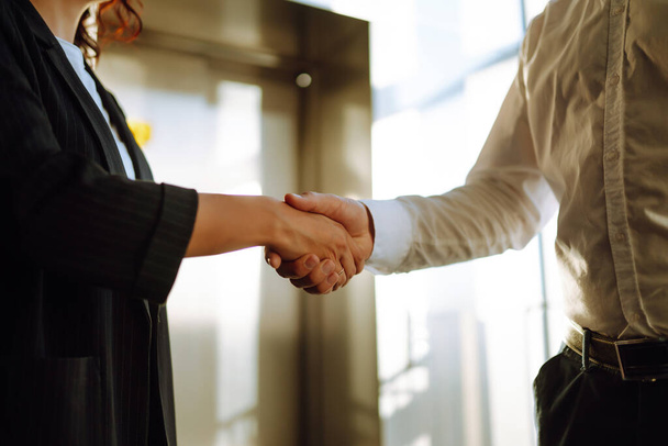 Close Up of business people shaking hands after contract meeting at customer office. Business etiquette, congratulation, merger and acquisition concepts. - Foto, imagen