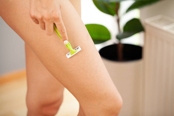 Skin care and health, fit woman shaving her legs with razor. - Φωτογραφία, εικόνα