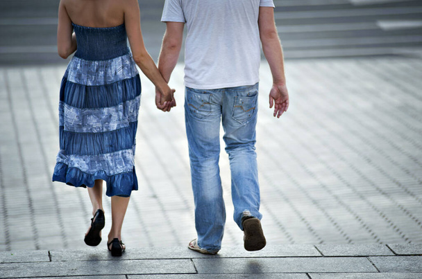 Couple walking and holding hands. - Фото, зображення