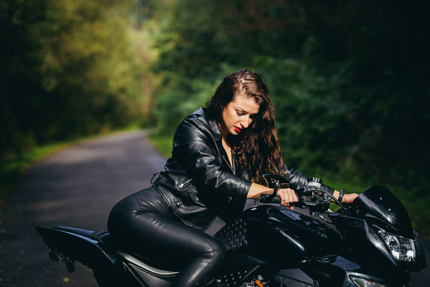 Biker sexy woman sitting on  motorcycle. Outdoor lifestyle portrait - Photo, Image