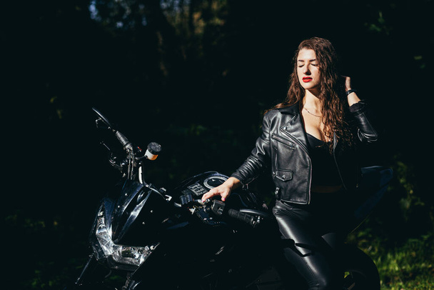 Biker sexy woman sitting on  motorcycle. Outdoor lifestyle portrait - Foto, imagen
