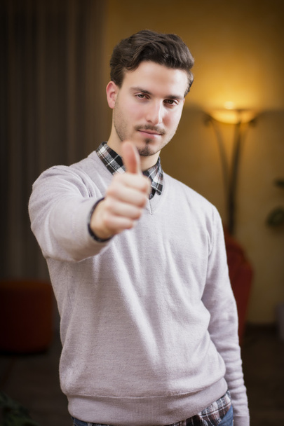 Attractive young man with thumb up doing OK sign - Photo, image