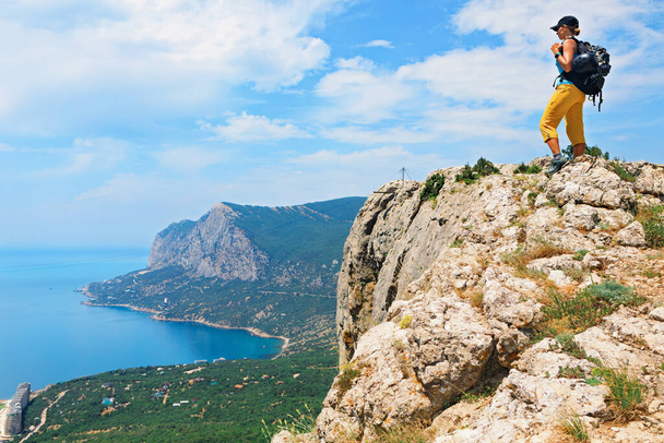 Young active woman stand on mount top. Look at amazing sea landscape. Family travel adventure, hiking activity, healthy lifestyle, exploring nature on summer vacation. Weekend day walking tour. - Φωτογραφία, εικόνα