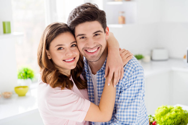Close up photo of charming tender passionate girl man married couple enjoy family weekend hobby dish meal preparation hug embrace in kitchen house indoors - Valokuva, kuva