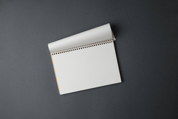 Open notepad on a gray background. - Φωτογραφία, εικόνα