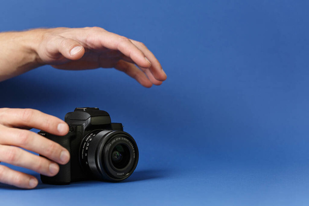 Digital camera is taken by male hands. - Фото, зображення