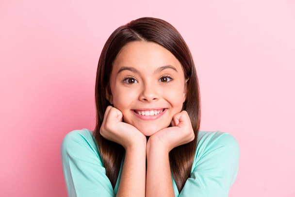 Photo of cheerful lovely sweet little hispanic lady long hairstyle hands hold face cheekbones toothy shiny white smile wear turquoise sweatshirt isolated pink color background - 写真・画像