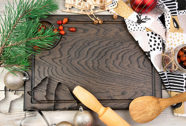 https://cdn.create.vista.com/api/media/small/416018256/stock-photo-cutting-board-rolling-pin-pine-branch-and-red-berries-on-a-light-wooden-background