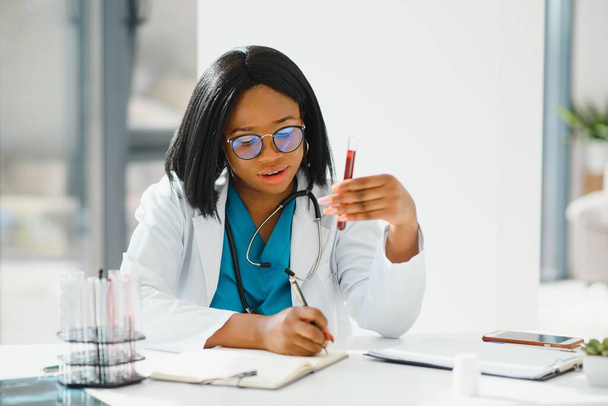 African American doctor working in her office at clinic - Foto, imagen